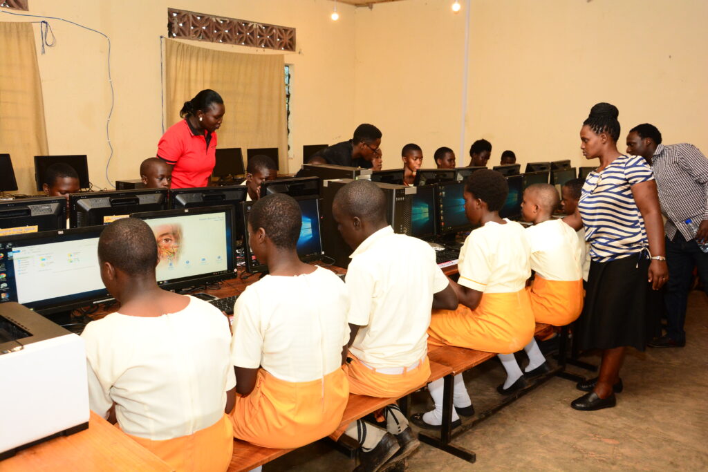 Students learning computer skills in a donated school computer lab in Uganda
