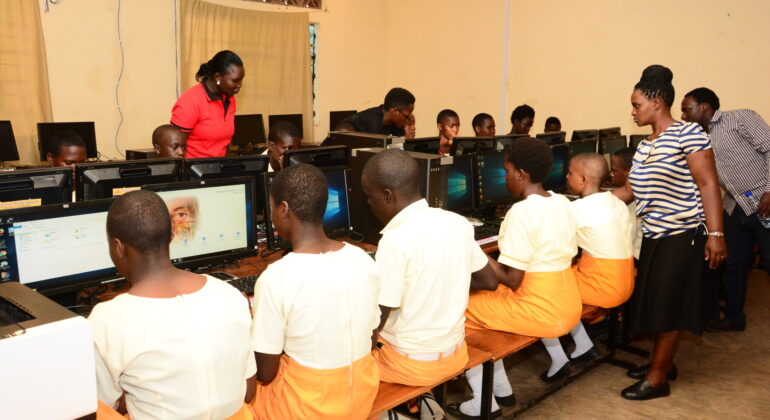 Students learning computer skills in a donated school computer lab in Uganda