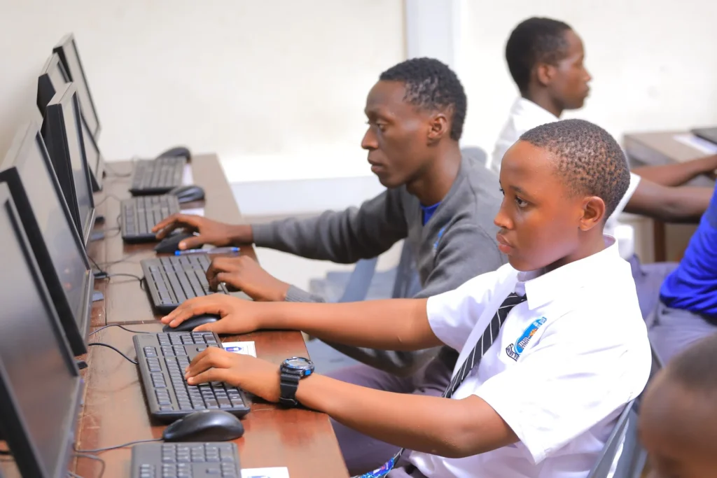 Students practising typing in a new school computer lab in Uganda